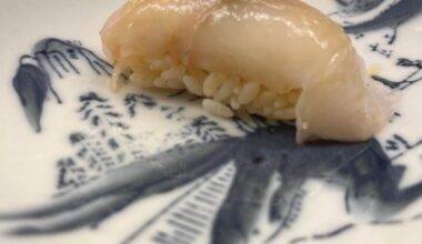 Aged Turbot nigiri with some small dried fishes as topping.