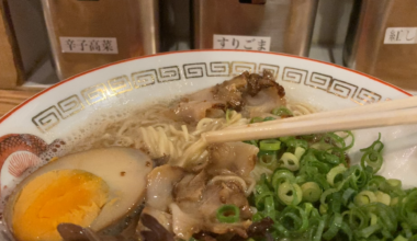 Pulling thin noodles out of Hakata tonkotsu soup at Debuchan in Tokyo