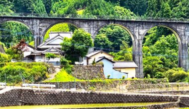 View of an old stone bridge and small village in the ricefields of Oita Prefecture [OC]