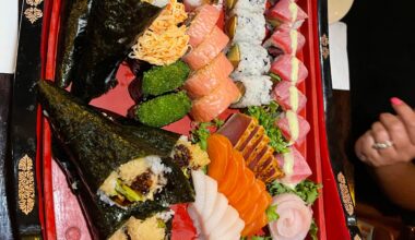 Last nights sushi boat filled with hand rolls, rolls, and sashimi