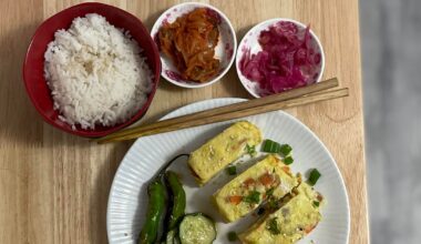 Brekkie - egg roll, shishito peppers, cucumber salad and some kimchi