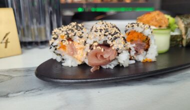 Tuna bathed in sesame seeds and neon light