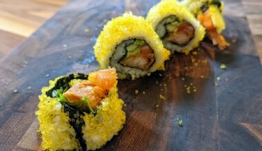 Homemade spicy salmon, avocado, and tempura roll. Coated with gold tobiko