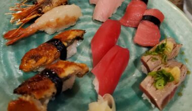 Nigiri platter, sweet shrimp, yellowtail, toro, unagi, bluefin, and scorched toro with a delightful citrus, garlic, and green onion garnish