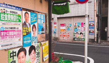 Suburban corner of Tokyo, surrounded by campaign posters on a silent road.