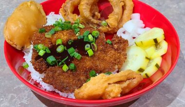 Pork Katsu with rice. Tempura sweet potato slices and onion rings also. And some sweet and sour pickles I made earlier today.