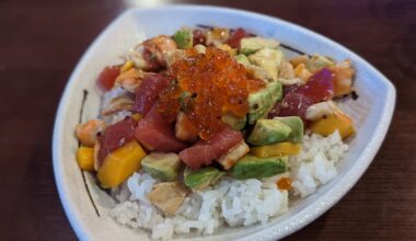 I commented earlier that I need to try the poke bowl from my local spot... Here it is, with a rainbow roll and some sashimi uni.