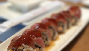 Happy Ending Roll (Salmon Tempura Roll topped with Seared Tuna, Garlic Ponzu, and Eel Sauce