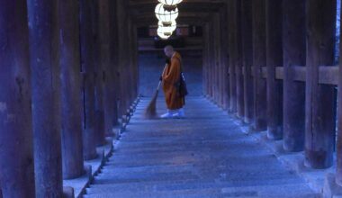 Monk sweeping stairs at Hasedera in Nara