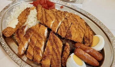 $7 platter of Japanese curry rice with pork katsu, chicken katsu, shrimp fry, sausages, eggs, and salad at “Go Go Curry” Ikebukuro