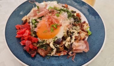 Yakisoba topped with an egg and copious amounts of aonori and katsuobushi