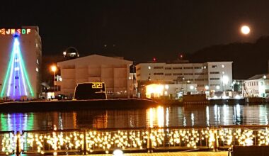 December's Long Night Moon overlooking a Japan Self Defense Force submarine illuminated in holiday lights [Yokosuka, Japan]