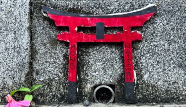 Miniature Torii gate on a sidewalk in Harajuku