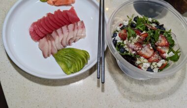 Ahi and yellowtail sashimi, avocado and a arugula berry goat cheese salad