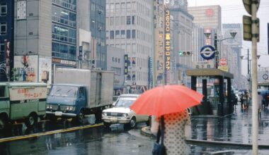 A rainy day in Tokyo back in 1971. Made in Japan "automatic" umbrellas were crazy popular in the Soviet Union and even were considered a status symbol, especially "Three Elephants" brand. Does anyone recognize the brand logo on the second image? It's from a Soviet anti-speculation poster.