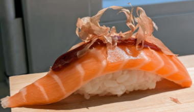 Homemade salmon nigiri, unagi sauce, katsuobushi