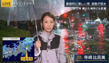 ANN reports from the streets of Hachioji, where heavy rain has caused a street to flood. A city employee in orange is warning people on bikes to turn back.