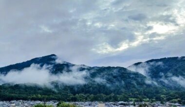 Mist clings to Mt. Hiei in the NE corner of Kyoto City. One of Kyoto's 17 UNESCO World Heritage Sites, Enryaku-ji Temple, just behind and to the left of the summit, is the head temple of esoteric Tendai Buddhism. This mountain is one of the biggest training grounds for priests in Japanese Buddhism.